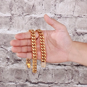 Detail of hand holding a gold Cuban link chain with a sparkling diamond encrusted clasp