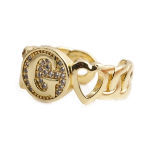 Detail of gold-plated open ring featuring a G-letter charm and hollow heart shape