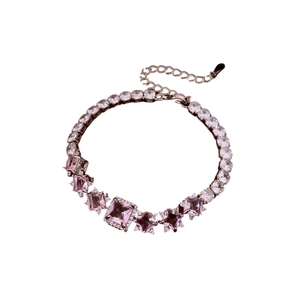Elegant silver bracelet with square pink and clear zircon crystals on white background