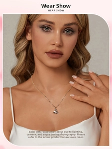 Detailed view of S925 sterling silver paper plane necklace worn by a female model