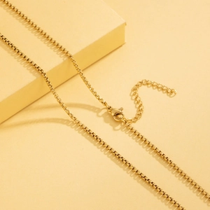 Golden stainless steel box chain necklace with lobster clasp and extension link detail