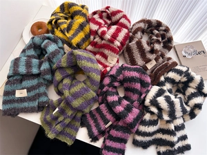 Flat lay of colorful striped wool scarves with ins tags on a white table background