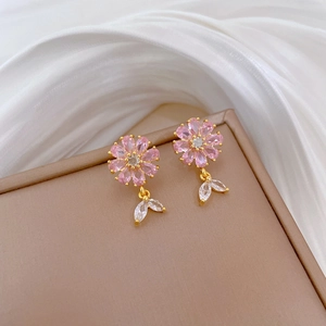 Close-up of pink flower earrings with marquise crystal leaves on gold settings