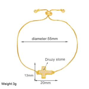 Detail view of adjustable gold cross bracelet with shimmering druzy stone and dimensions