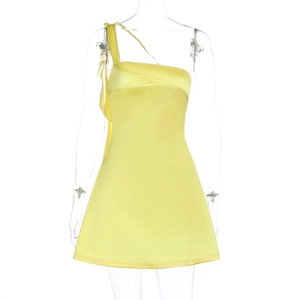 Close-up detail of yellow satin one-shoulder dress fabric with slim fit cut on mannequin