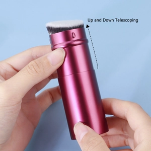 Detail of rose gold retractable makeup brush with angled bristles for travel