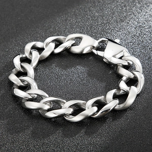 Close-up of a silver chunky Cuban link bracelet with a lobster clasp on a black background
