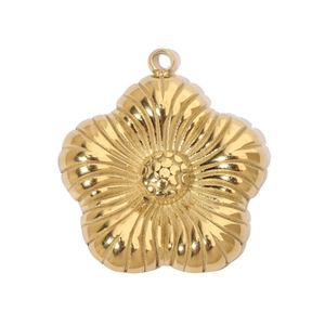 Detailed view of a gold-plated flower charm pendant with radial textures and polished finish