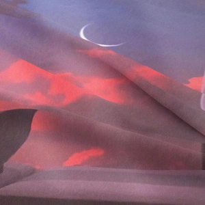 Macro detail of Bohemian tapestry showing starry moon and soft textile texture