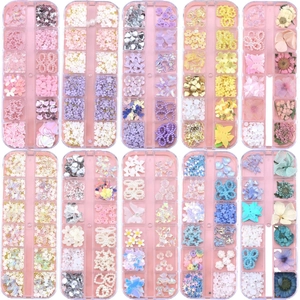 Set of 10 boxes with diverse nail art charms including butterflies stars and pearls