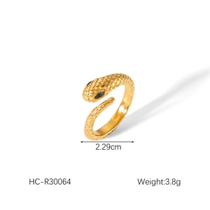 Detail of gold snake ring with blue gem eyes and 2.29cm width textured scale surface