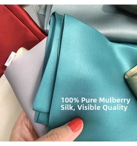 Close-up of premium 100% mulberry silk fabric layers showing natural glossy texture
