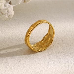 Minimalist 18K gold-plated stainless steel star open ring on textured background