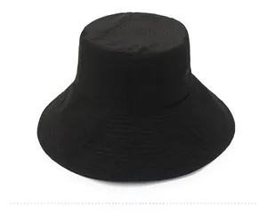 Close-up of black breathable bucket hat with mesh fabric texture and wide brim for sun protection