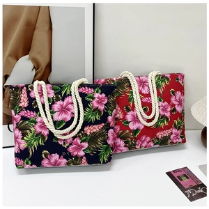 Detail of blue and red floral tote bags with pink hibiscus prints and rope handles