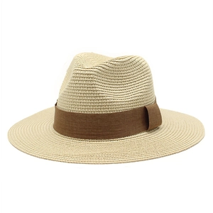 Close-up of beige woven straw fedora hat with brown fabric decorative band detail