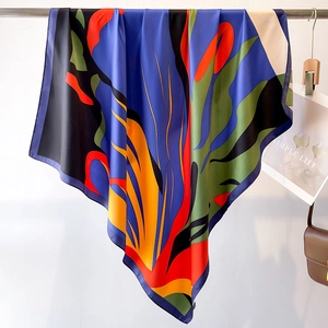 Detail of multi-color silk scarf with abstract patterns and elegant satin texture finish