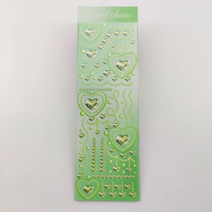 Detail of green 3D heart stickers and pearl chain patterns for creative DIY decor