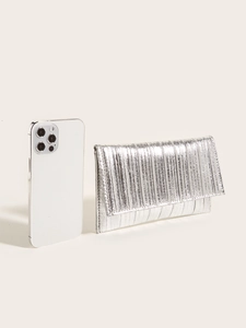 Silver pleated clutch bag compared with a smartphone to show compact size