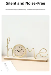 Detail of creative gold metal 'home' clock with silent movement on a wooden base