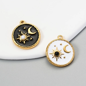 Detailed view of black and white enamel sun and moon charms in gold stainless steel