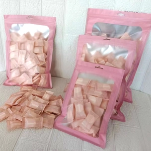 Macro view of portable compressed towels in pink bag for travel and skincare use