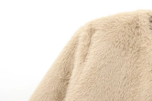 Close-up of soft beige faux fur jacket showing high-quality fluffy plush texture
