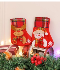 Detail of red Christmas stockings featuring 3D reindeer and snowman with plaid trim