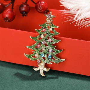 Christmas tree brooch with colorful crystals and green enamel on festive background