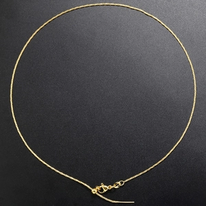 Detail view of gold-plated snake chain necklace with adjustable slider clasp and tail chain