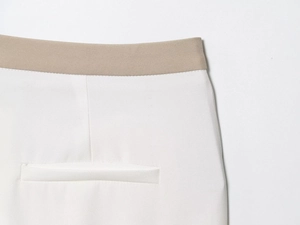 Detail of short sleeve blazer suit featuring contrast elastic waist and welt pocket
