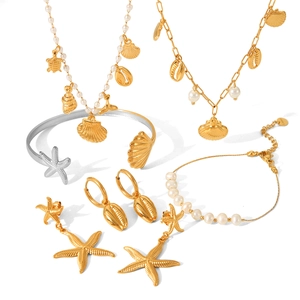 Ocean themed jewelry set featuring starfish, shell and turtle motifs in gold and silver