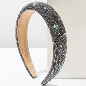 Detail of a thick sponge headband with gray rhinestones and rainbow star crystals