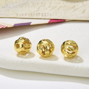 Macro view of gold hollow fish pattern beads for DIY jewelry making accessories