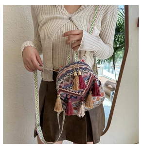 Close-up of bohemian woven backpack featuring colorful geometric patterns and tassel details
