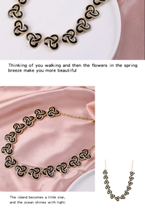 Macro view of vintage gold necklace with black enamel celtic knot links and extension chain