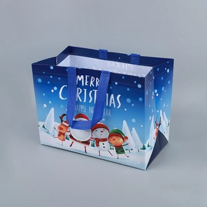 Christmas non-woven gift bag with Santa and reindeer illustrations and durable blue handles