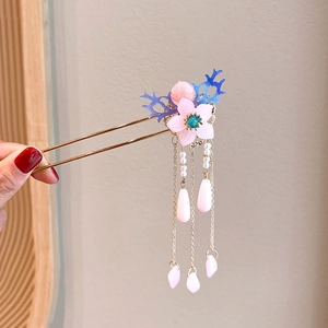 Detail of pink flower hair stick with tassel pendant for elegant updo hairstyles