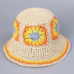 Close-up of handmade crochet sun hat featuring colorful floral patterns and woven texture
