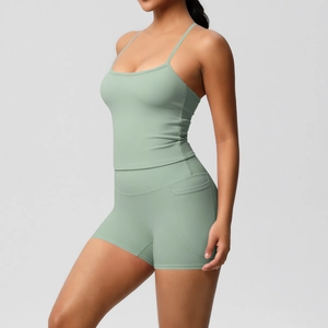 Detail of pea green yoga set showing side pockets on high-waist shorts and thin straps