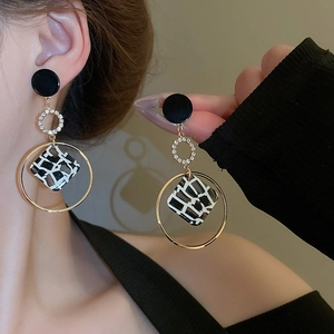 Detailed view of leopard star earrings with gold plating and geometric resin inlay