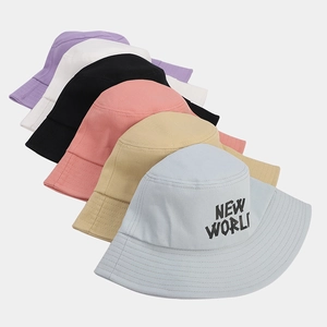 Detail showing various colors of cotton canvas bucket hats with NEW WORLD embroidery