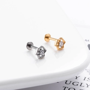 Macro shot of G23 titanium hollow flower star stud with zircon in gold and silver finish