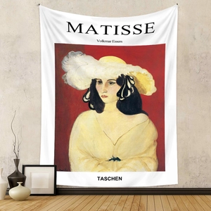 Detail of artistic Henri Matisse style tapestry with red and yellow portrait on a grey wall