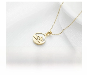 Detail of gold titanium steel necklace with a hollow lotus shell pendant on textured fabric