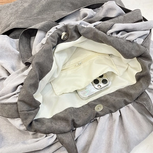 Interior detail of large gray tote bag featuring a zipper pocket and magnetic closure