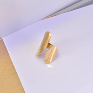 Close-up of polished 18K gold-plated wide band open ring with an asymmetrical design