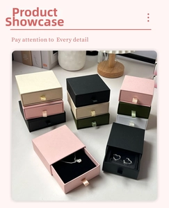 Detail view of drawer-style jewelry boxes with ribbon pulls and plush lining in multiple colors