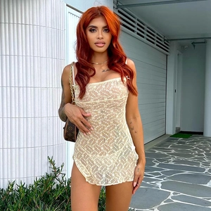 Detailed shot of beige lace cutout mini dress with slit on a model in street style