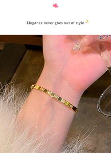 Close-up of elegant gold titanium steel bracelet with cubic zirconia on a woman's wrist